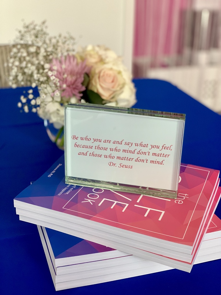 Stack of The Self-Love Workbook at an event