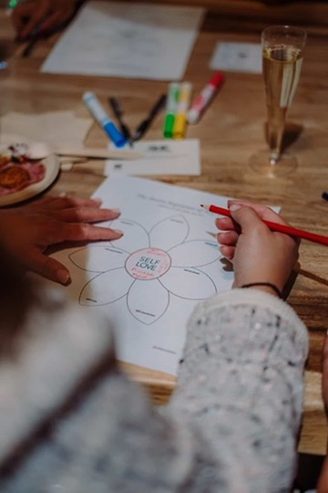Completing a self-love exercise from The Self-Love Workbook by Dr. Shainna Ali