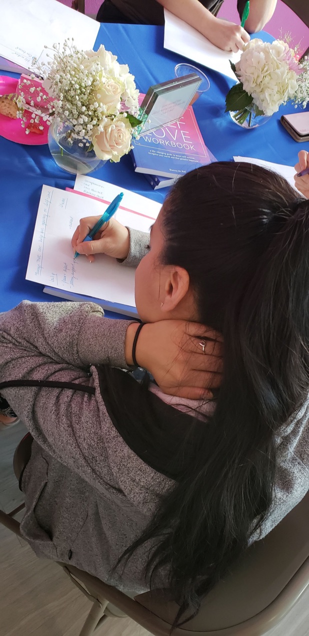A reader working through The Self-Love Workbook