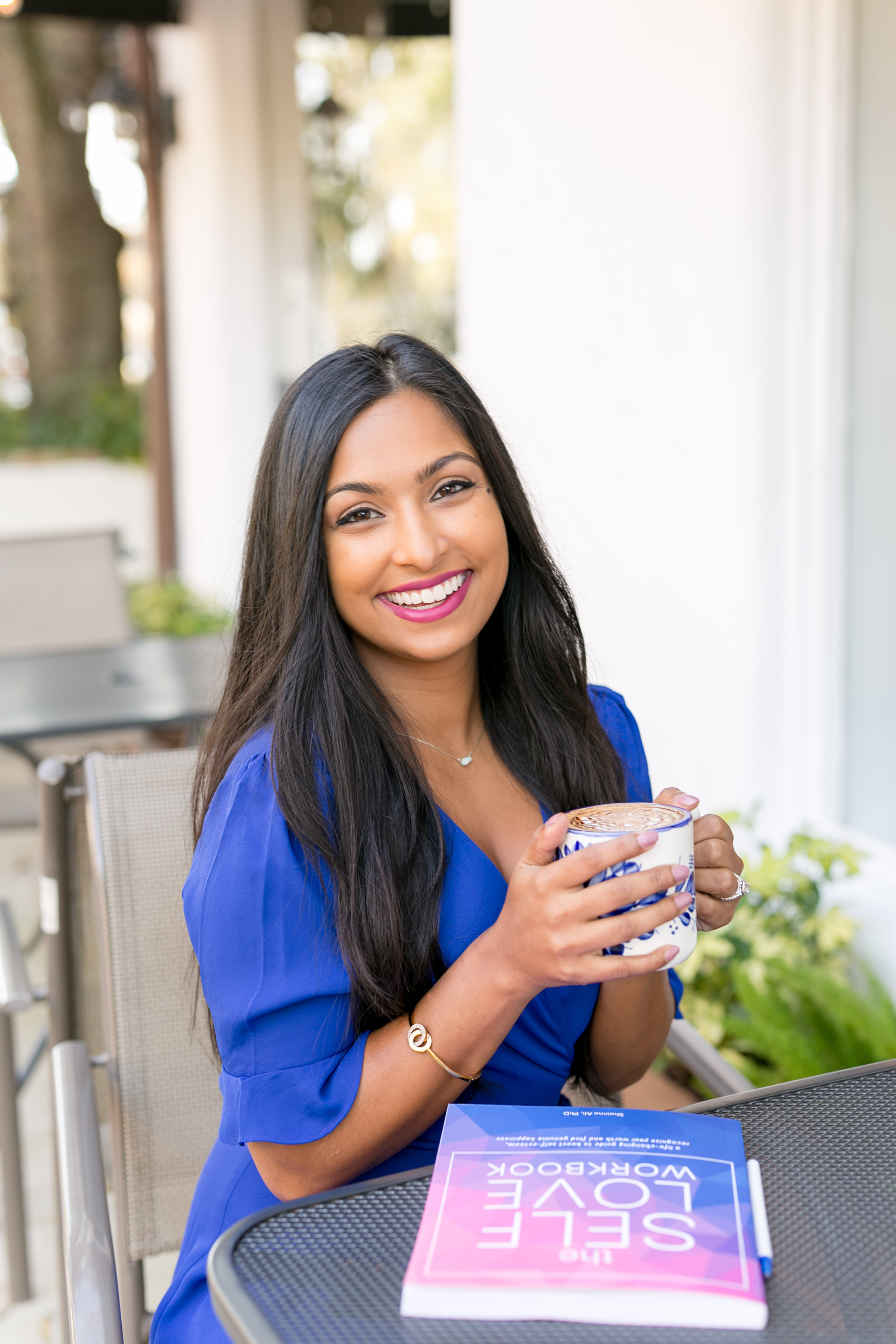 Dr. Shainna with The Self-Love Workbook at café