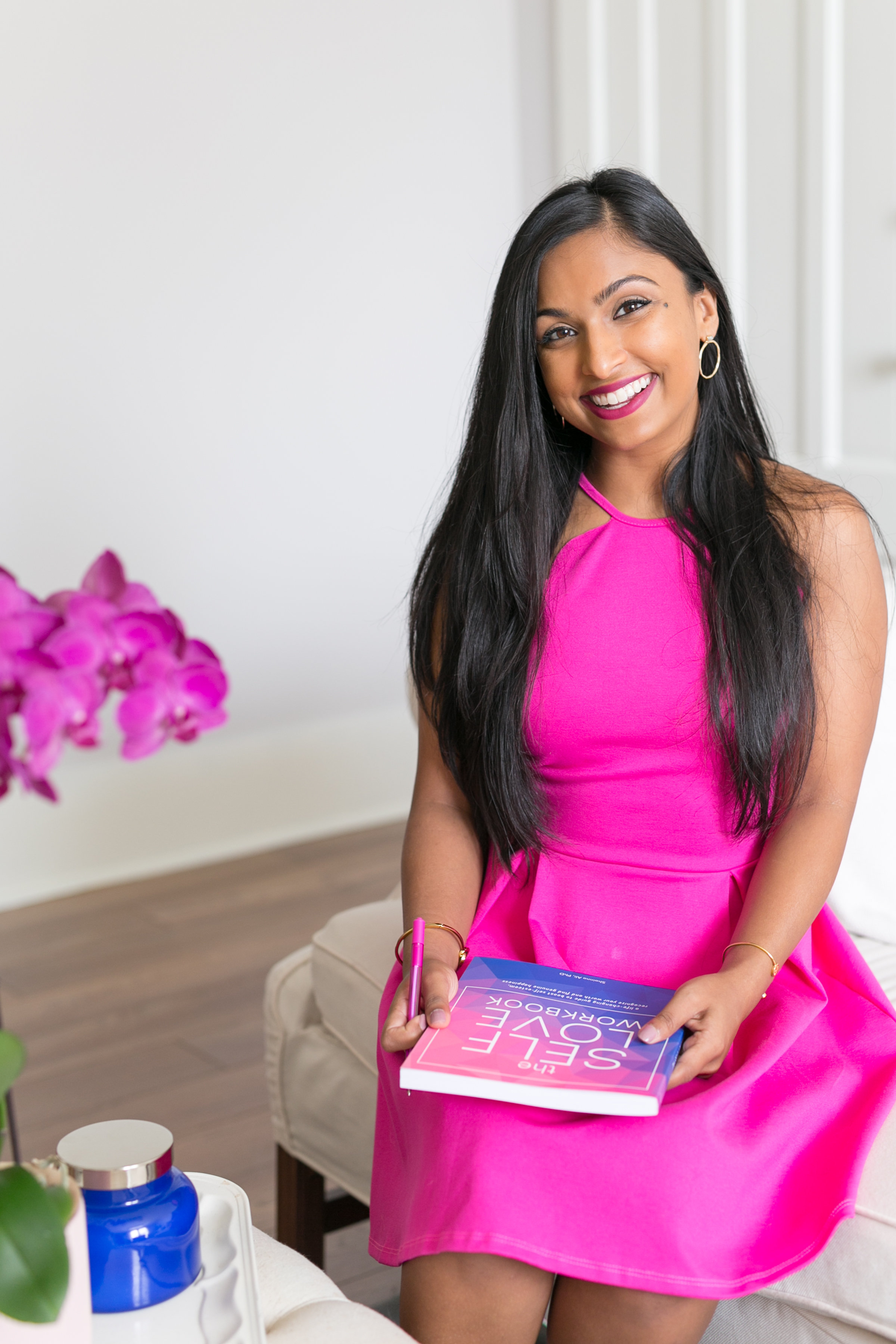 Dr. Shainna holding The Self-Love Workbook